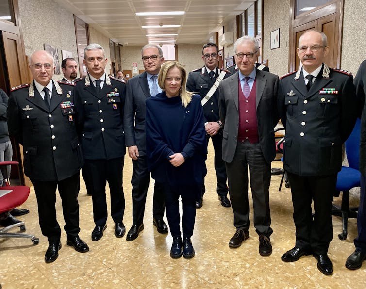 Italian prime minister Giorgia Meloni poses with a group of officials in Sicily.