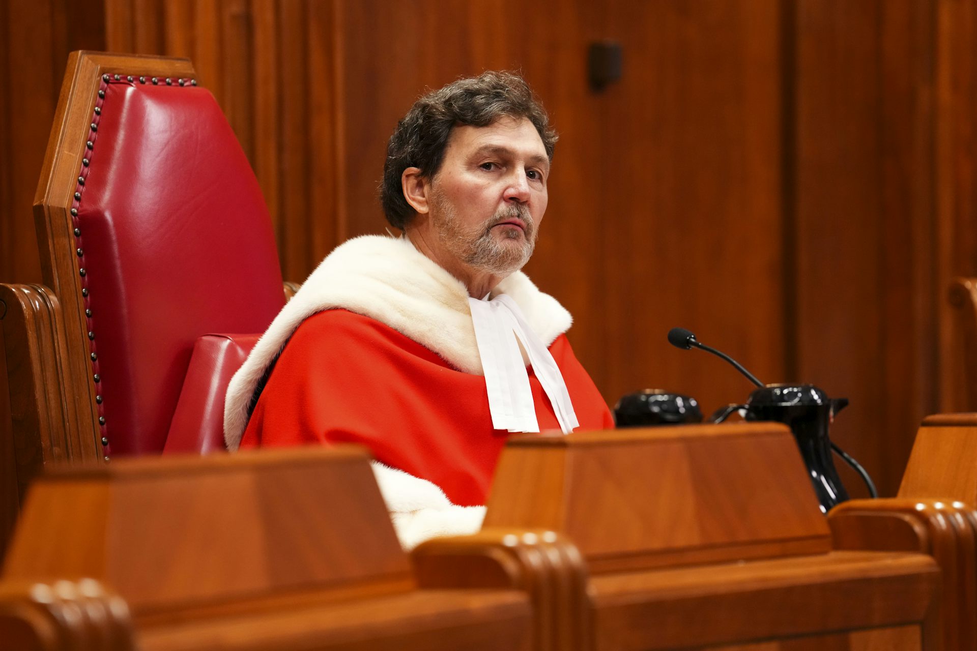A man with a goatee in red and white robes.