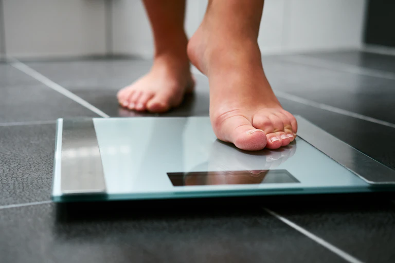 Woman stands on scales