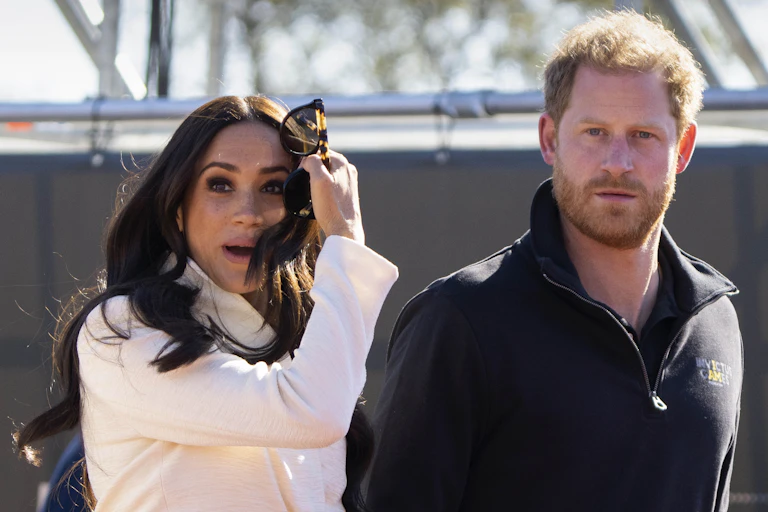 Meghan and Harry, looking hunted