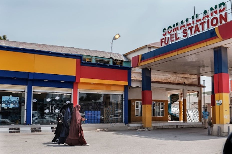Women walk past a fuel station in Hargeisa