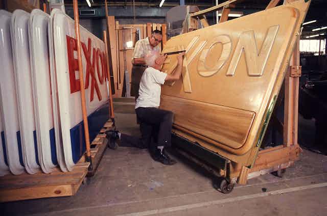 Man in workshop with Exxon sign