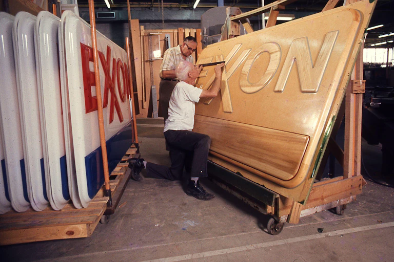 Man in workshop with Exxon sign