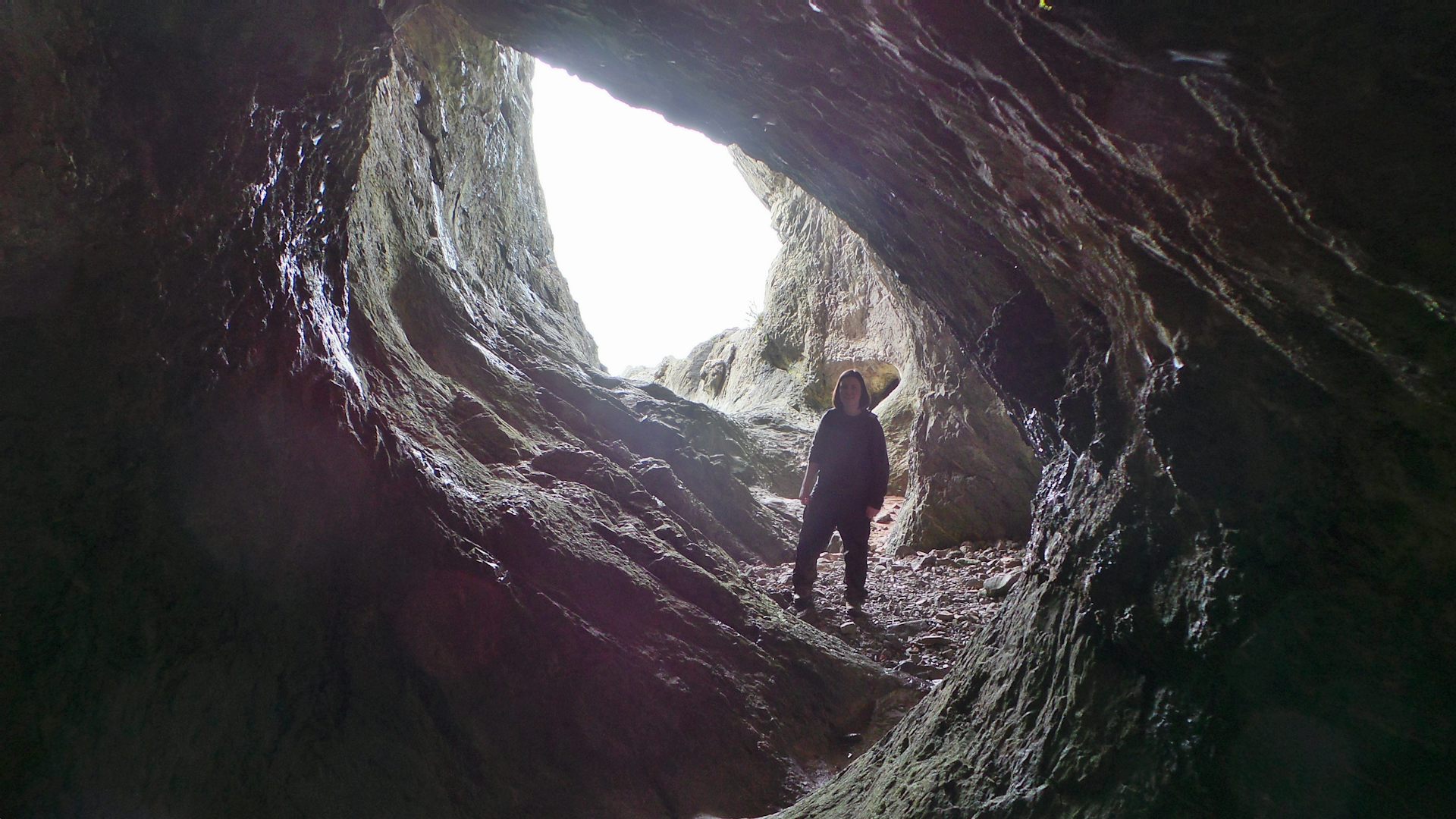 Person standing inside a cave