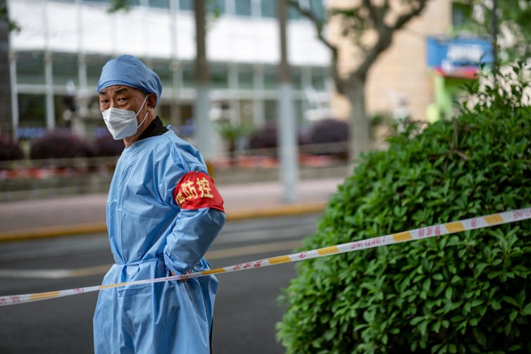 A man wearing full PPE in Shanghai, May 2022.