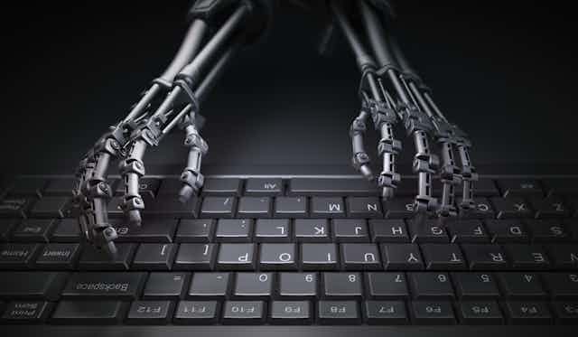 A pair of robot hands on a keyboard.