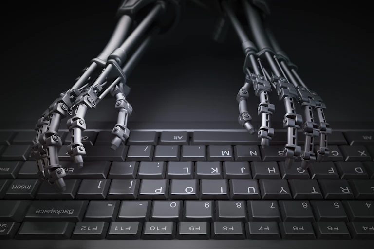 A pair of robot hands on a keyboard.