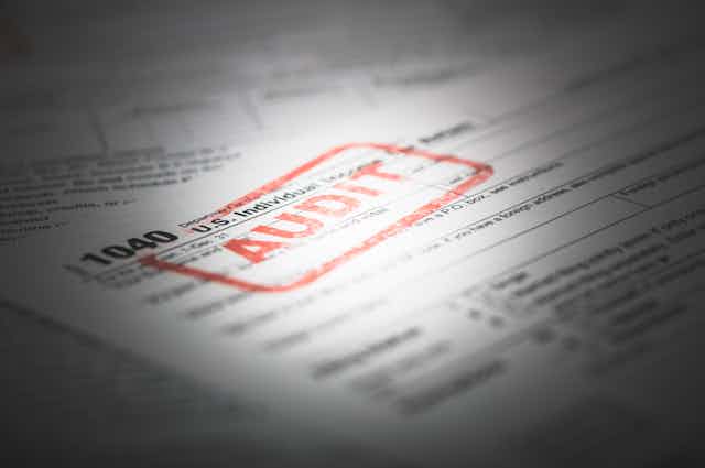 An individual tax return with a red stamp on it that says 'AUDIT'