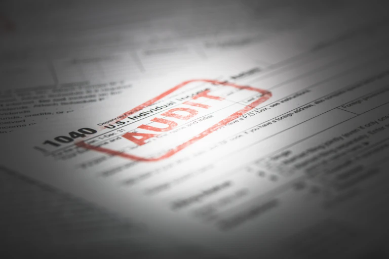 An individual tax return with a red stamp on it that says 'AUDIT'