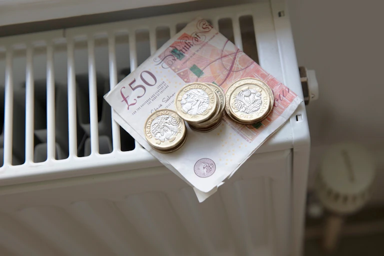 Coins and notes on a radiator.
