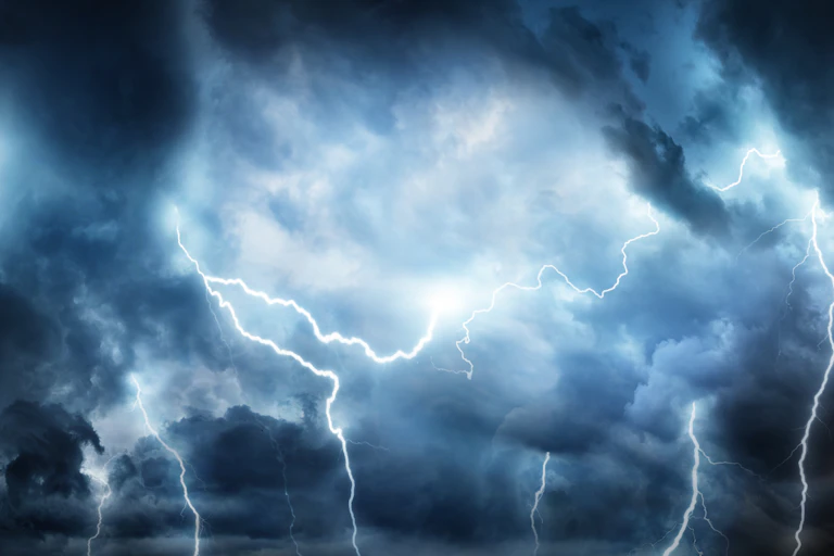 Lightning thunderstorm flash over the night sky