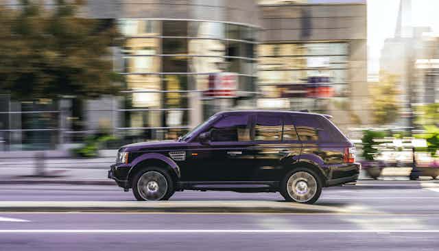 An SUV driving along a street