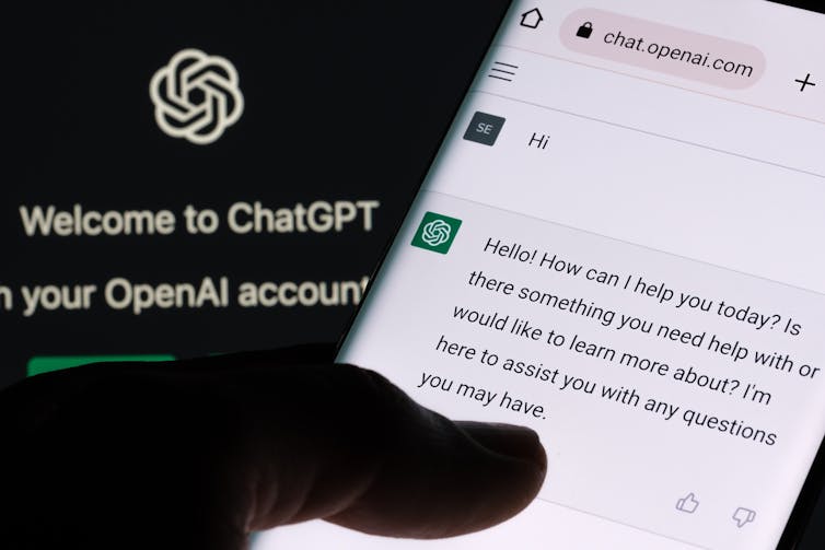 ChatGPT chat bot screen seen on smartphone and laptop display and Chat GPT login screen in the background