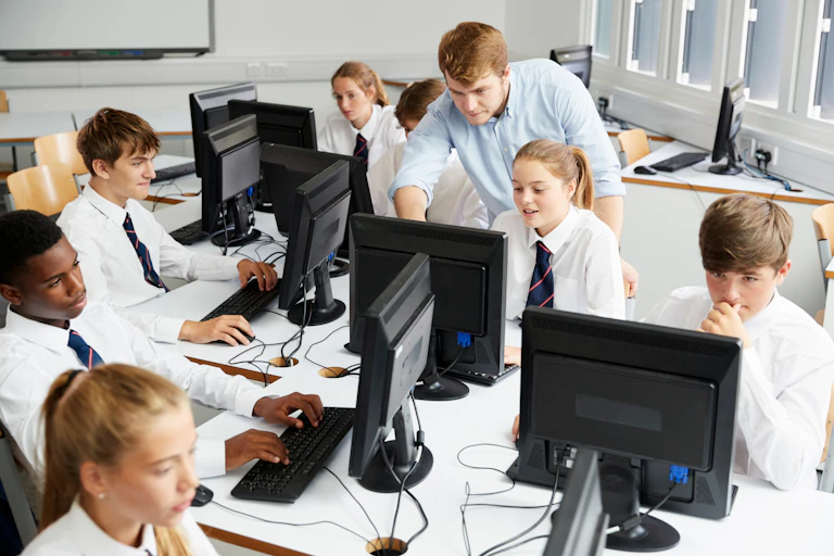 Class working on computers wearing uniform with ties