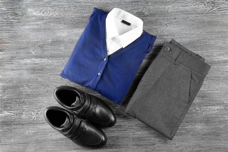 Folded school uniform and shoes