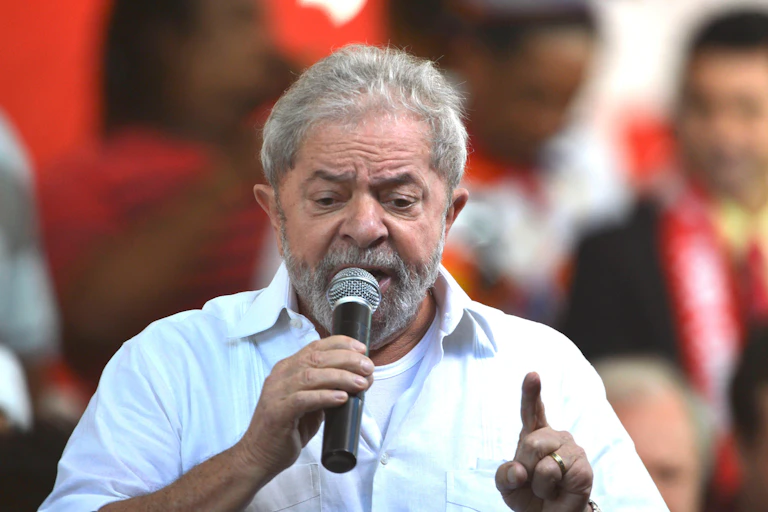 A man with grey hair holding a microphone.