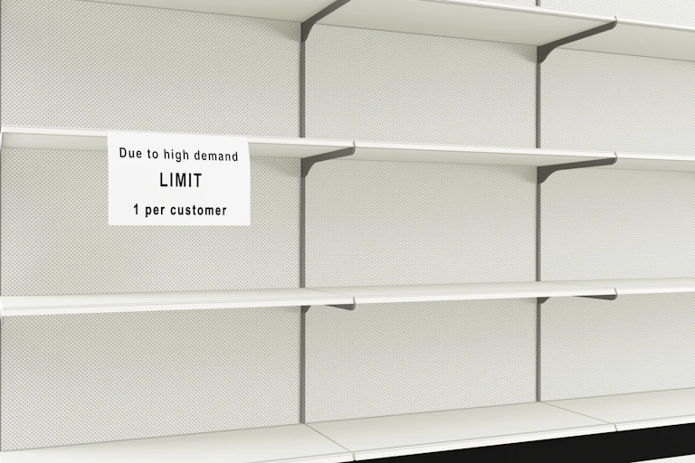 An empty shelf with a sign indicating customers are limited to one box due to demand.
