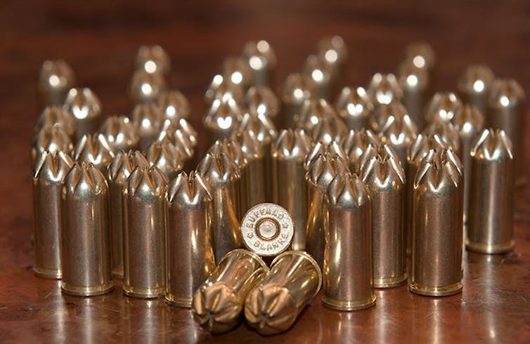 A number of handgun cartridges with the tops pinched closed and no bullet.