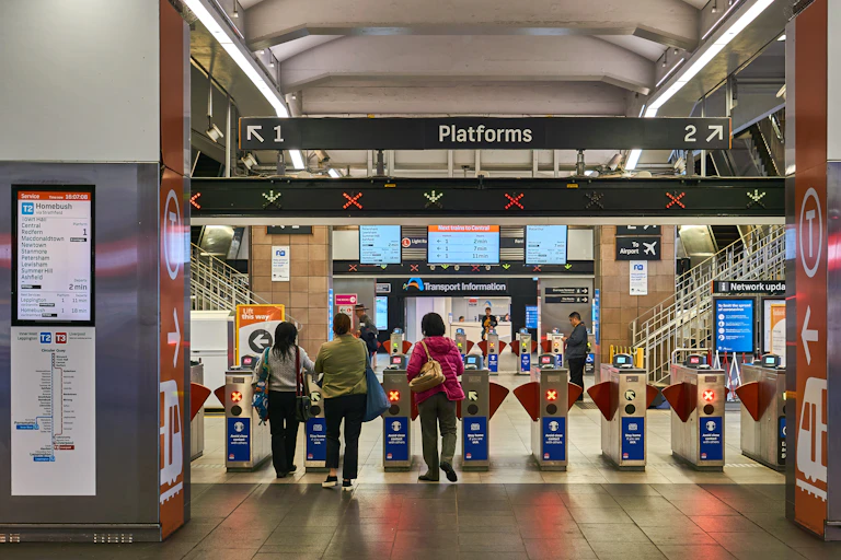 People approaching ticket barriers at a train station