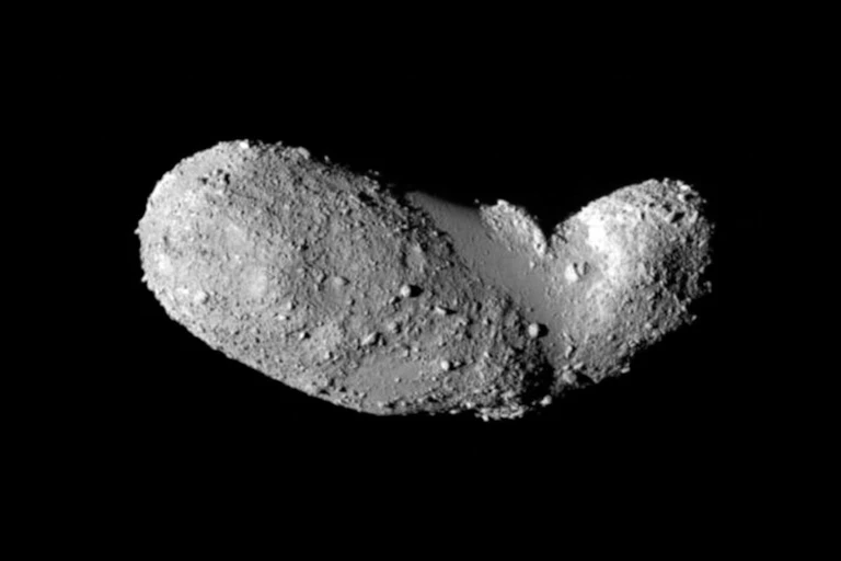 A peanut shaped grey rock floating on a black background