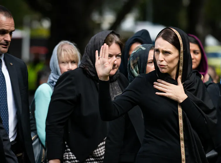 A woman in black with her head covered