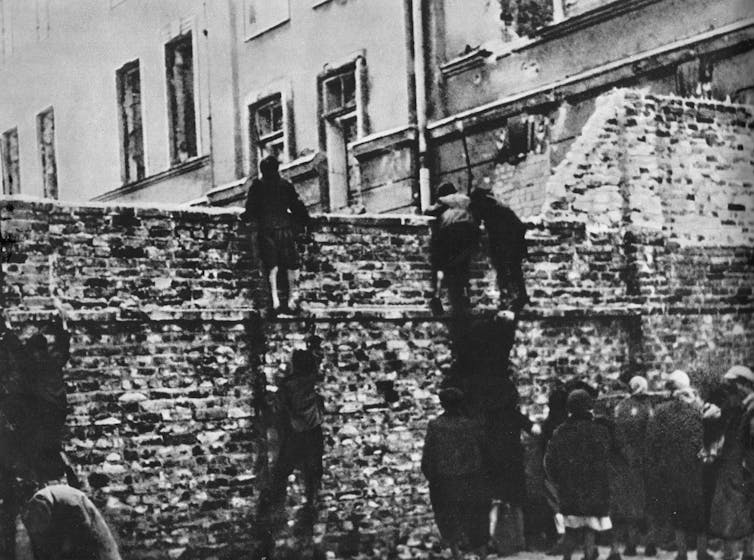 Children climbing a wall.