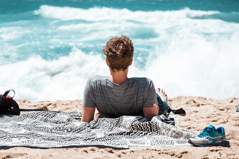 Man lays on the beach