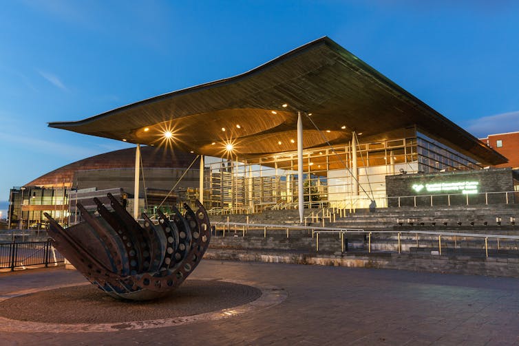 The Senedd building lit up in the evening