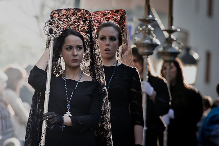 Women Catholic devotees wearing traditional mourning dress