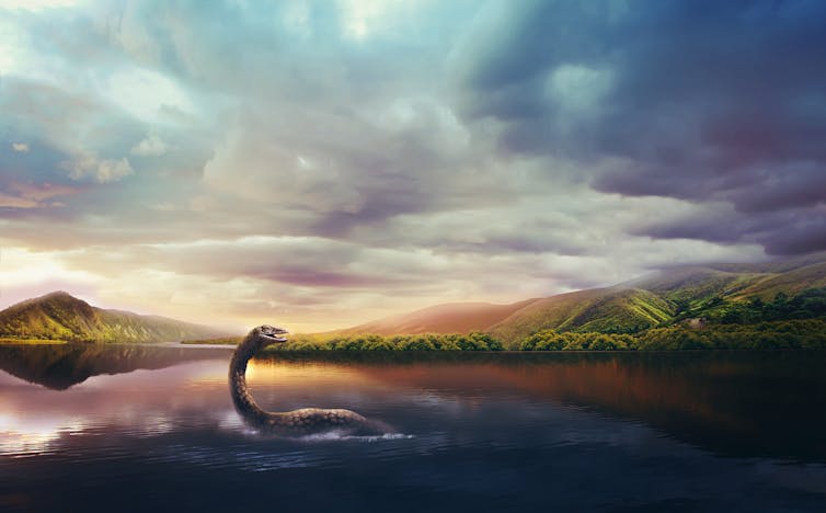 Under a sky of blue and gold, the Loch Ness monster surfaces the dark blue water to show its small head and elongated neck.