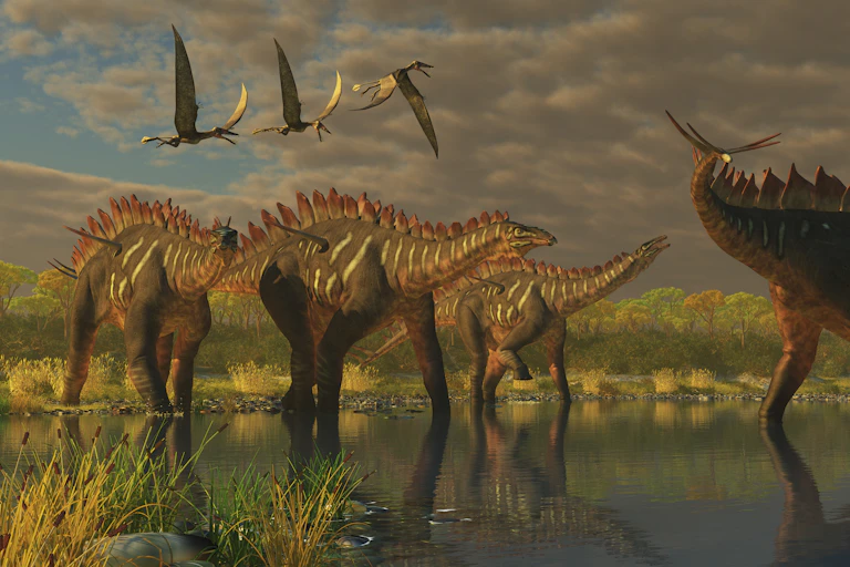 Flying dinosaurs are in the air over other dinosaurs standing in marshland