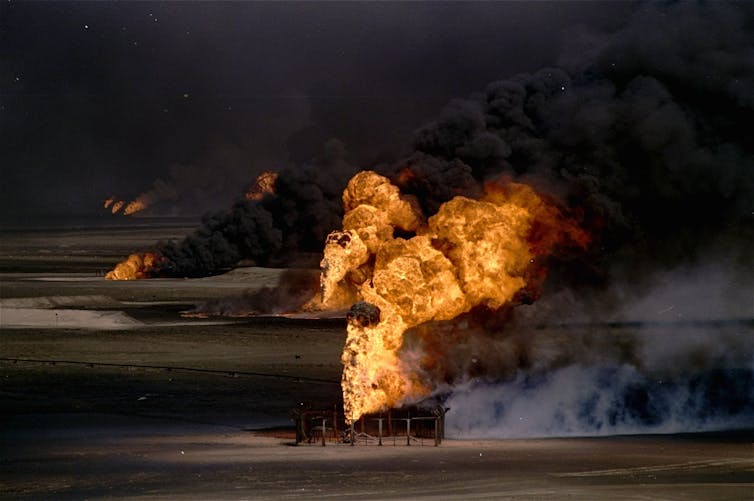Flame and smoke spew from oil well