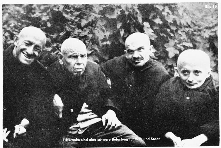 Four disabled men, dressed in black.