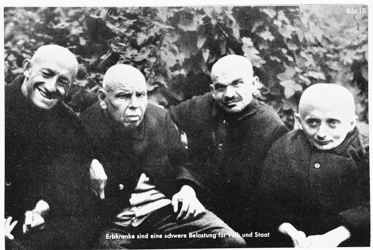 Four disabled men, dressed in black.