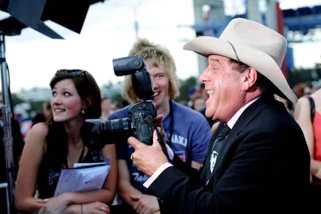 Molly Meldrum holds a camera
