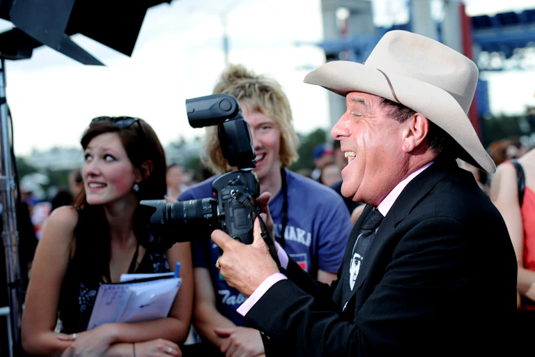 Molly Meldrum holds a camera