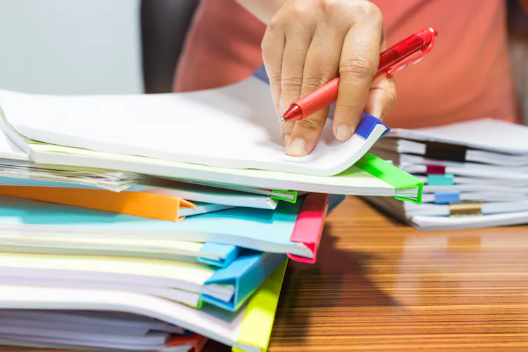 Teacher marking assignments.