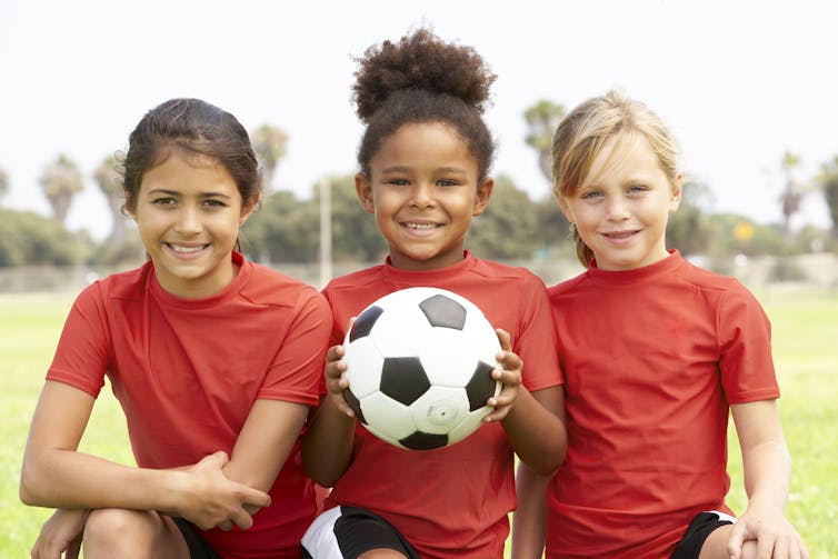 Three girls with football