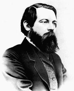 Black and white photograph of Engels with side parted hair and long beard.
