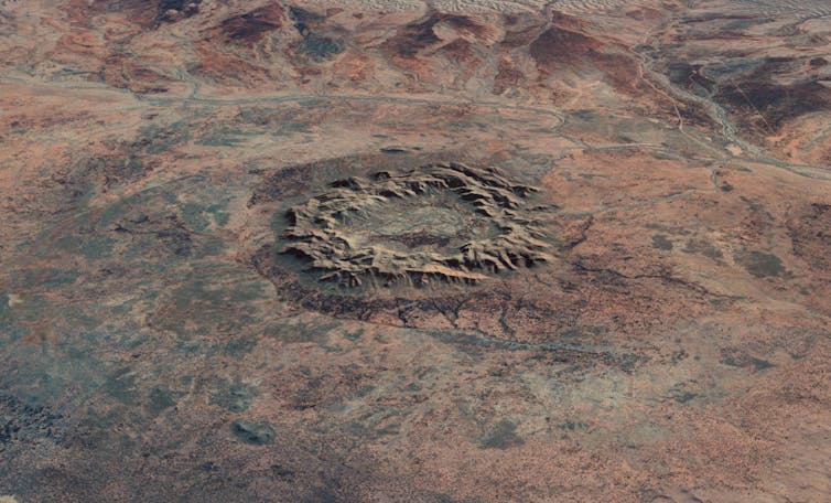A large rocky circle on a red landscape seen from above.