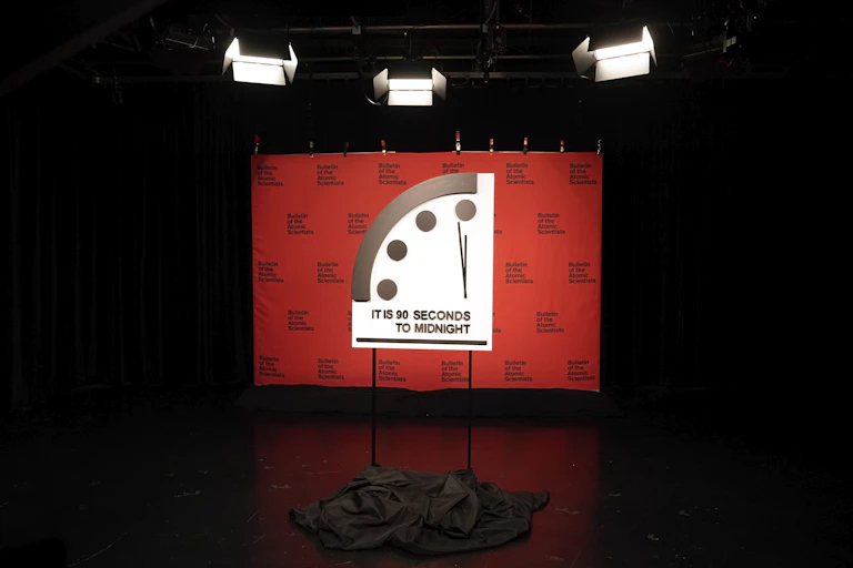 a large display showing the top-lefthand corner of a clock with the text IT IS 90 SECONDS TO MIDNIGHT
