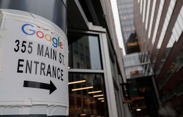 A sign points to Google's headquarter entrance on 355 Main St 