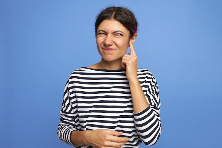 Woman touching her ear