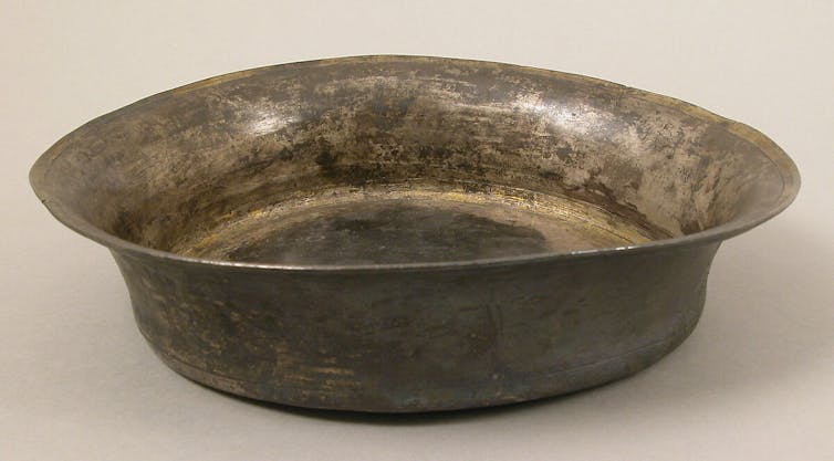 A round rimmed metal vessel.