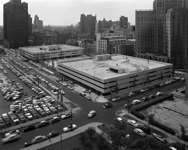 Bird's-eye view of midcentury parking lots and parking garages.