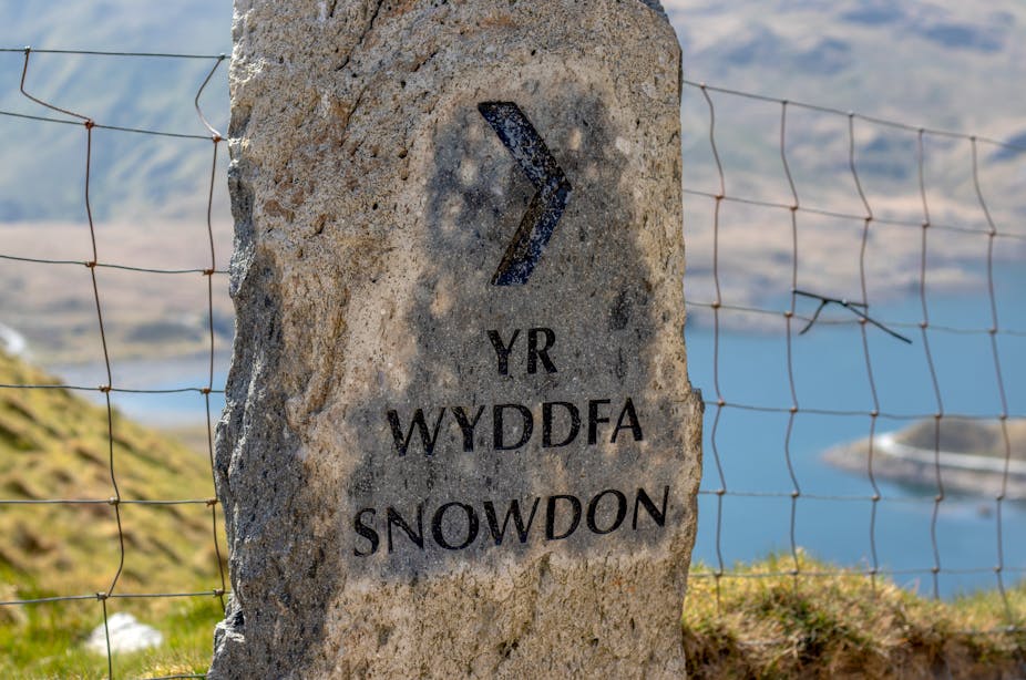 Large rock with printed words 'Yr Wyddfa' and 'Snowdon' printed on it