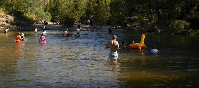 people swimming in river