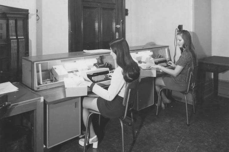 Two women in the 1970s at typewriters