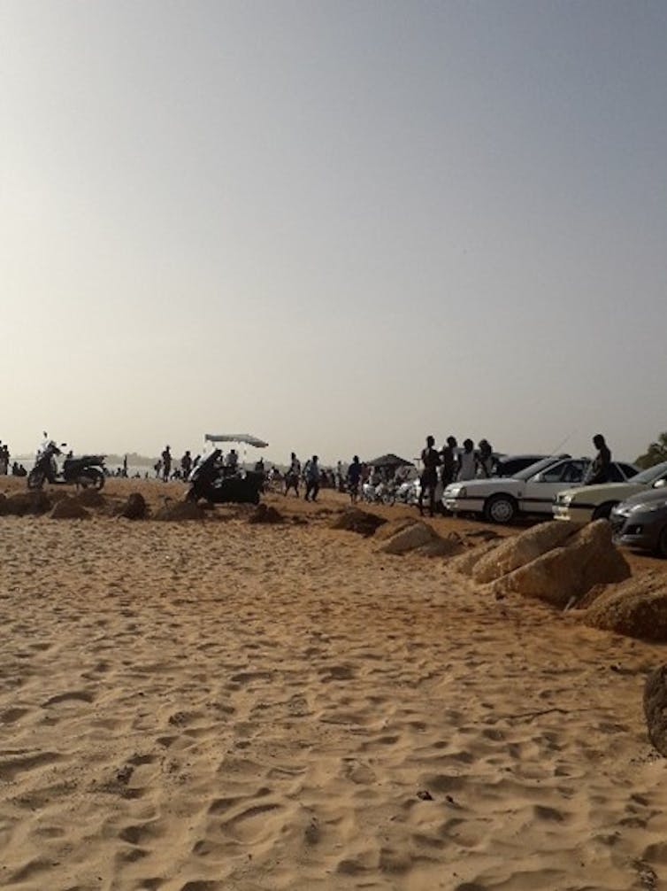 Des voitures sont garées aux abords d’une plage au Sénégal