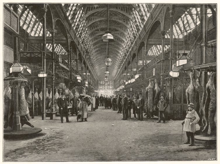 A black and white photograph of an interior meat market